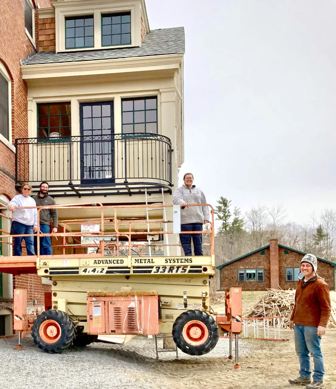 Workers and a lift beside the Inn during restoration